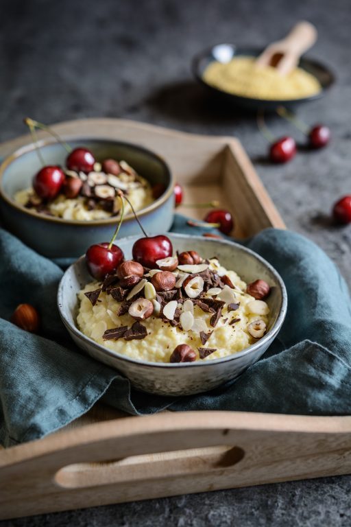 Millet porridge topped with chocolate pieces, hazelnuts, almond